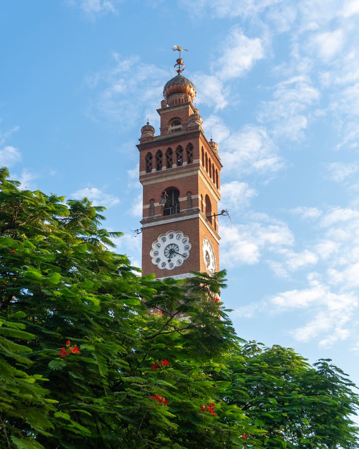services-01 Scenic view of the iconic clock tower against a clear blue sky in Lucknow, India.